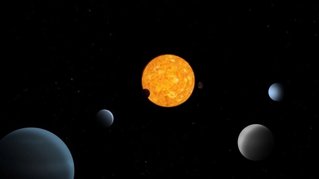TOI-178, ao centro, e os seis planetas que a orbitam são representados nesta ilustração.