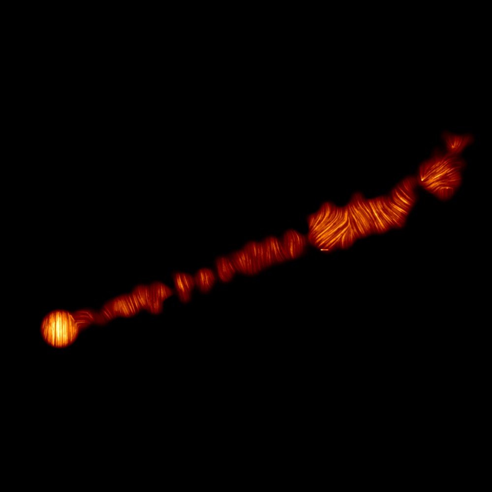 O jato de matéria lançada pelo buraco negro no centro da galáxia Messier 87 (M87), em luz polarizada captada pelo Atacama Large Millimeter / submillimeter Array (ALMA), do Chile.