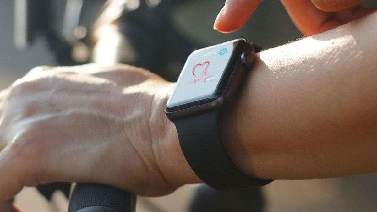 Homem ostenta um smartwatch o cara faz flexões no estádio um aplicativo  para monitoramento de batimentos cardíacos em um relógio inteligente queima  de gordura para perda de peso o atleta tem pulso