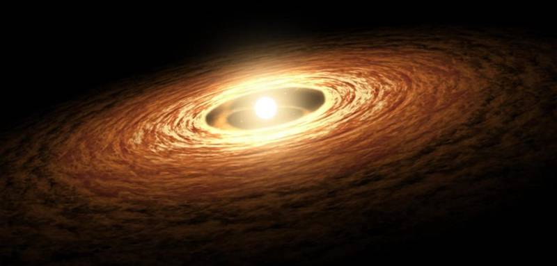 Impressão artística de um sistema planetário se formando. Ao centro temos a estrela, recém-formada, cercada por detritos e gases. É possível notar um espaço vazio próximo a estrela. Representando regiões onde o material volúvel foi expulso para partes mais externas do sistema